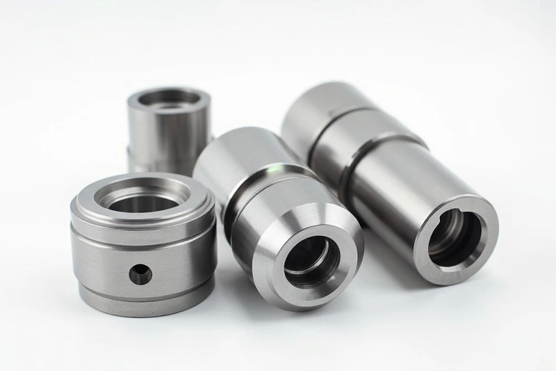 Close-up of precision cylindrical parts manufactured through custom aluminum fabrication, showcasing smooth surface finishes.