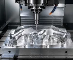 CNC machining center processing an aluminum alloy part, showing the spindle, cutting tool, metal workpiece, and realistic machining marks in an industrial workshop.