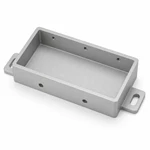 Bead-blasted anodized aluminum battery housing tray with an empty CNC-milled cavity and mounting ears.