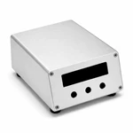 Angled studio view of custom brushed aluminum instrument housing with display opening and three evenly spaced circular control holes.