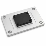 Custom CNC aluminum machine base plate securing a black mounting block with four socket-head screws.