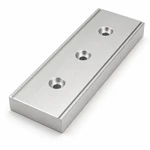Close view of a CNC machined aluminum guide rail showing counterbored mounting holes and side relief grooves.