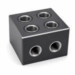 CNC-machined aluminum manifold block showing clean deep threads, concentric O-ring grooves and chamfered edges.