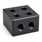 Hard-anodized CNC aluminum manifold block with four top ports, O-ring grooves and two front threaded ports.